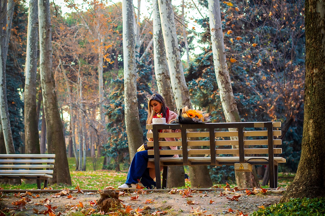 Woman sitting alone on a park bench, taking a quiet moment to herself