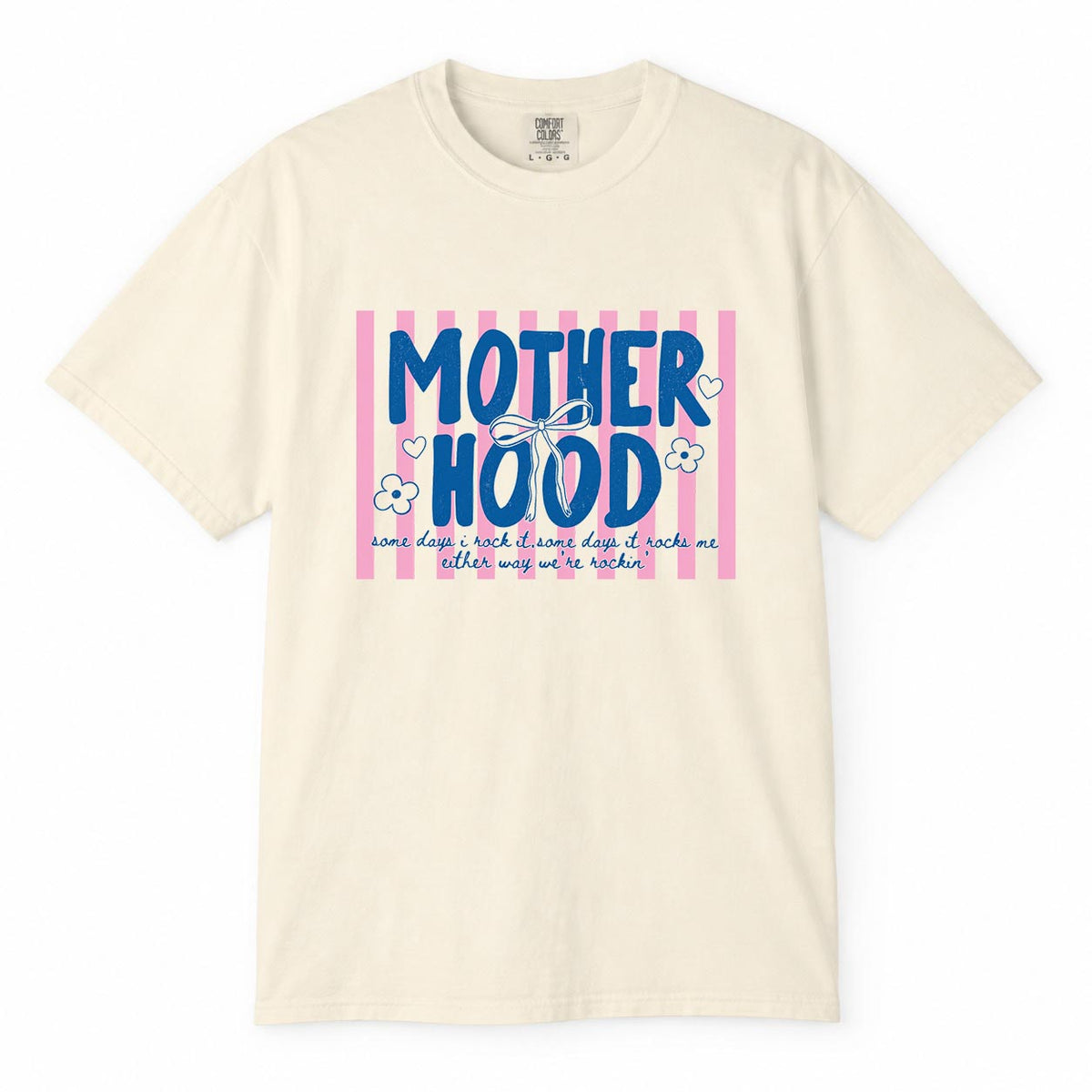Comfort Colors ivory t-shirt with pink striped "Motherhood, some days I rock it, some days it rocks me" mom life shirt design with bow and flowers